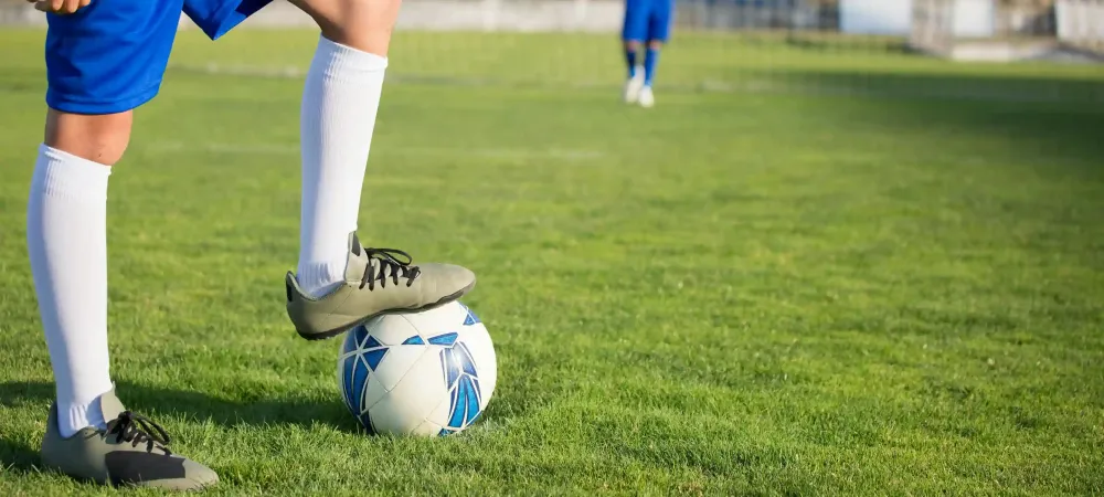 soccer player with foot on ball