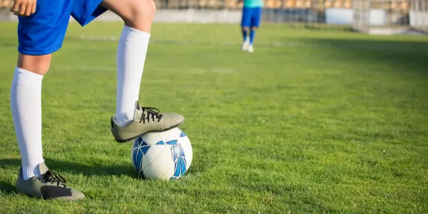 soccer player with foot on ball